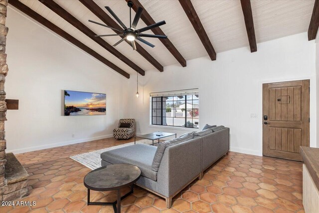 tiled living room featuring ceiling fan, beam ceiling, and high vaulted ceiling