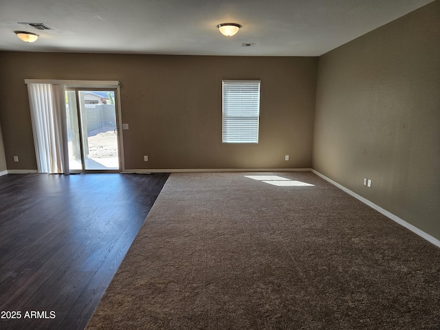 spare room featuring visible vents and baseboards