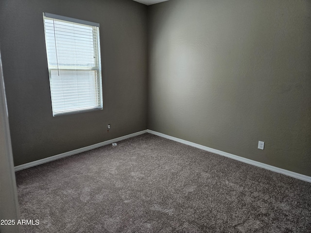 carpeted spare room with baseboards