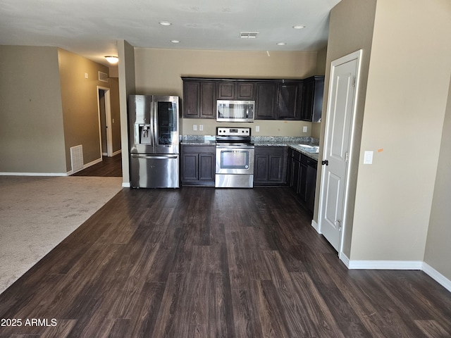 kitchen featuring dark wood finished floors, visible vents, and stainless steel appliances