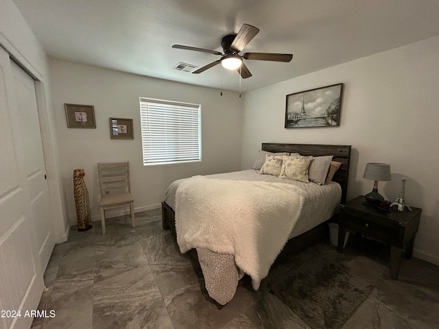 bedroom with ceiling fan and a closet