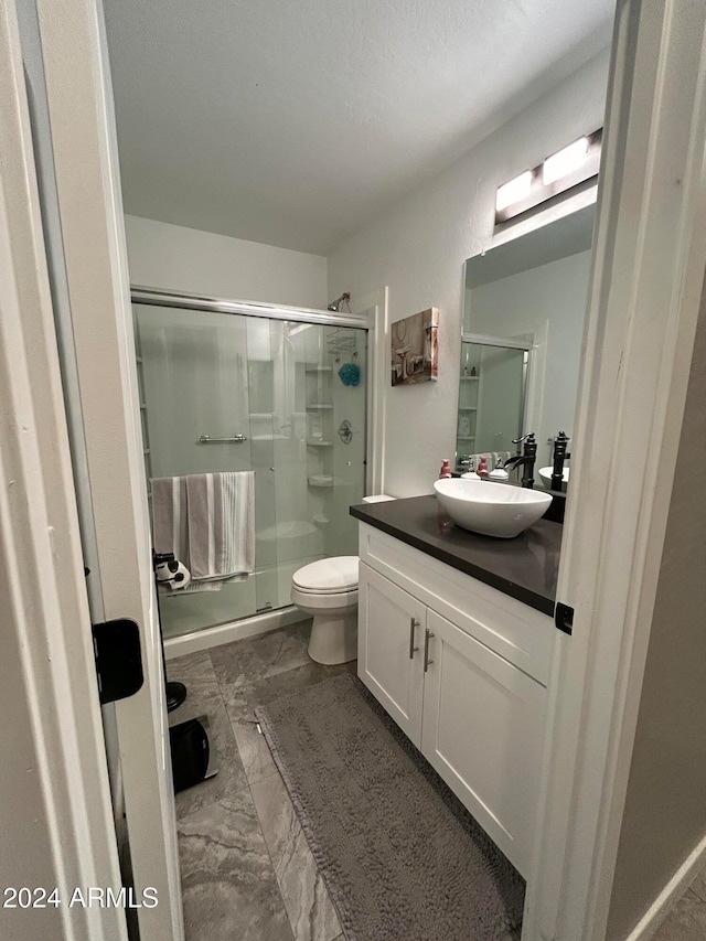 bathroom with vanity, toilet, and walk in shower