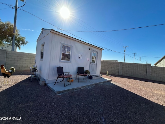 back of house with an outbuilding