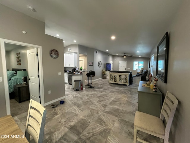 living room with ceiling fan and lofted ceiling