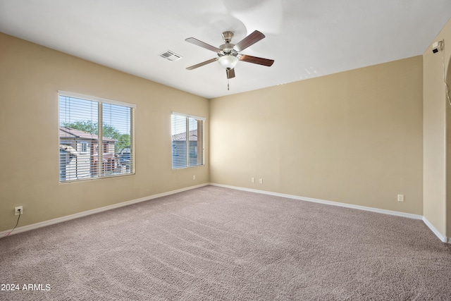 carpeted empty room featuring ceiling fan