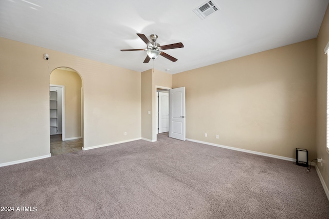 carpeted spare room with ceiling fan