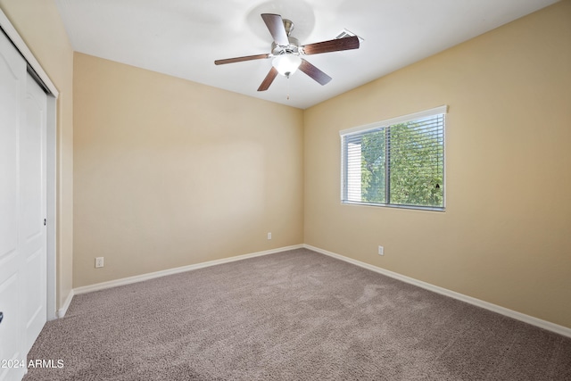 unfurnished bedroom featuring ceiling fan, a closet, and carpet flooring