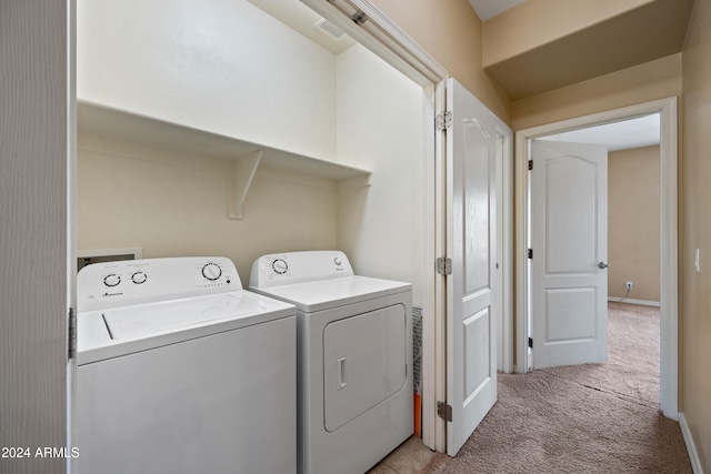 laundry area with light colored carpet and washing machine and dryer