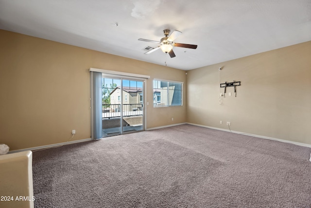 carpeted spare room featuring ceiling fan