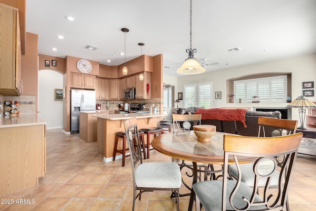 dining space with sink and light tile patterned floors