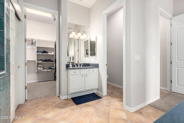 bathroom with vanity, toilet, and tile patterned flooring