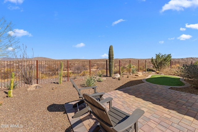 view of patio with a fenced backyard and a mountain view