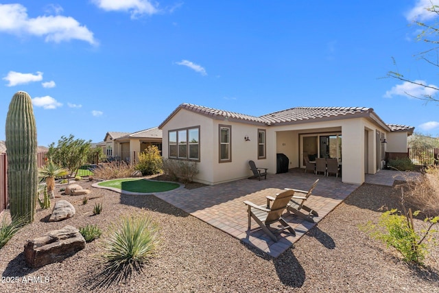 back of property with a patio area, fence, a tile roof, and stucco siding