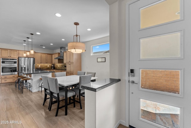 dining room with light wood-style floors and recessed lighting