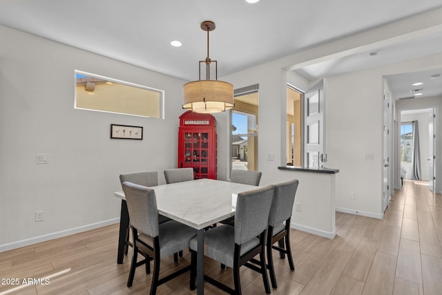 dining space with light wood-type flooring, baseboards, and recessed lighting