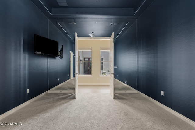 spare room with carpet and baseboards