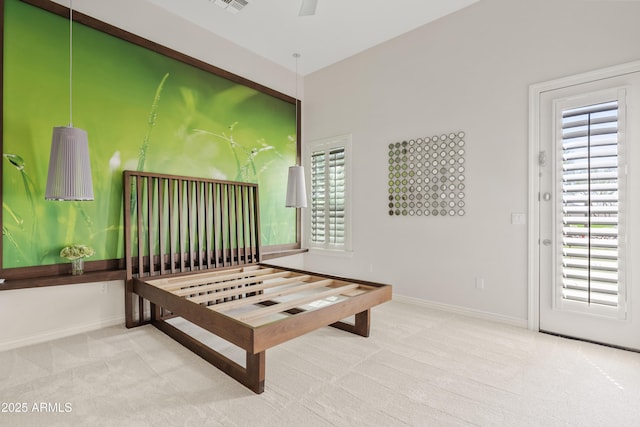 carpeted bedroom featuring visible vents and baseboards
