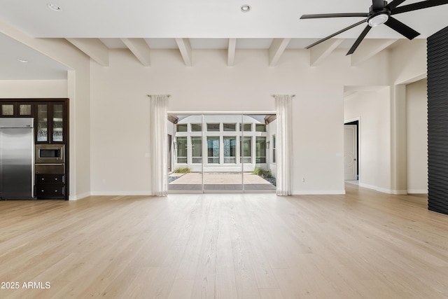 unfurnished living room with ceiling fan, recessed lighting, wood finished floors, baseboards, and beam ceiling