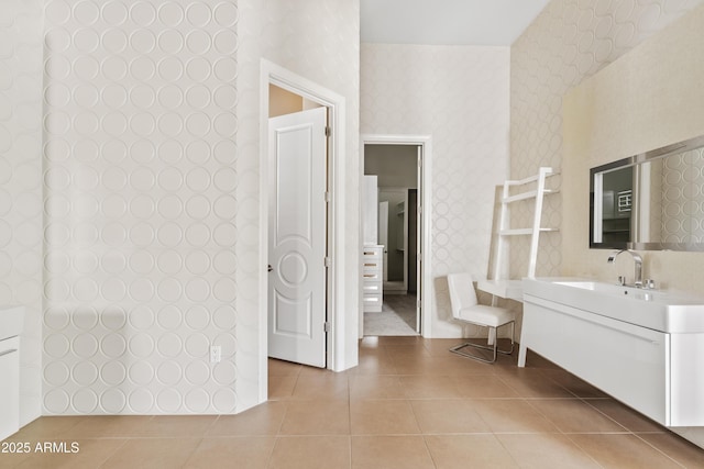 bathroom featuring tile patterned floors, vanity, and wallpapered walls