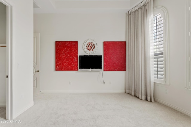 unfurnished bedroom featuring visible vents, baseboards, and carpet