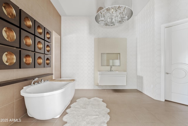 bathroom featuring tile patterned floors, wallpapered walls, and a soaking tub