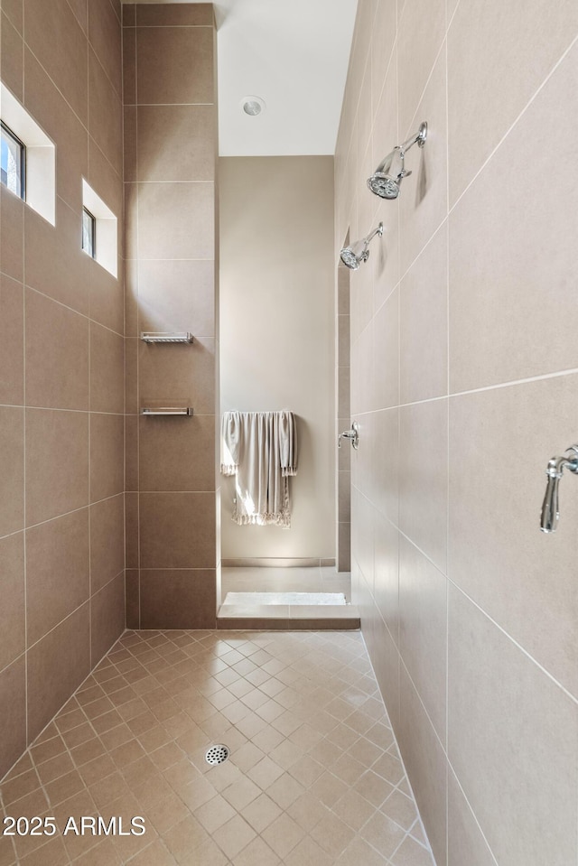 bathroom with a tile shower