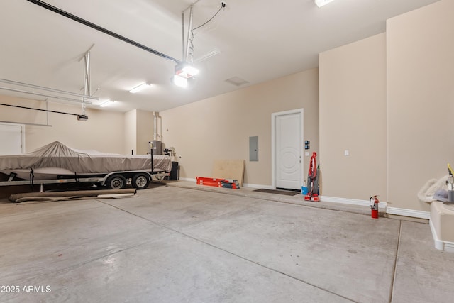 garage with a garage door opener and electric panel