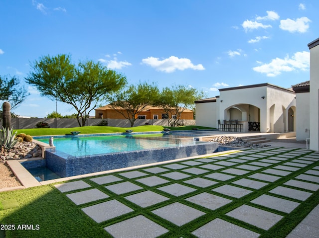 view of pool with a fenced in pool, a patio area, and fence