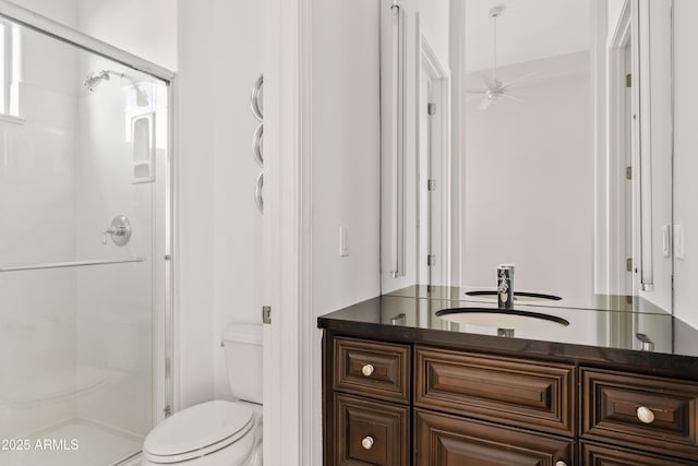 full bath featuring toilet, ceiling fan, a shower stall, and vanity