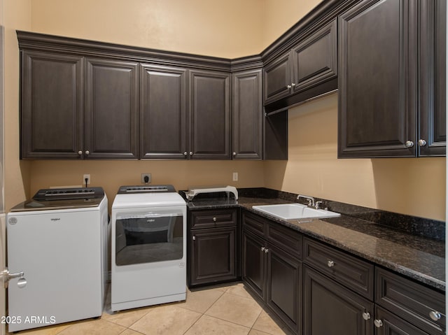 laundry area with light tile patterned floors, washer and clothes dryer, a sink, and cabinet space