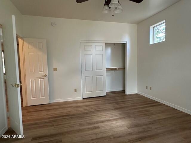 unfurnished bedroom featuring a closet, dark wood-type flooring, and ceiling fan