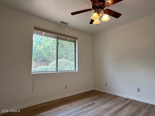 empty room featuring ceiling fan and wood-type flooring