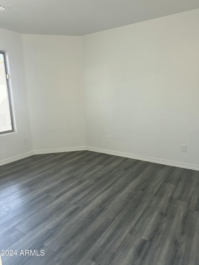 spare room featuring dark hardwood / wood-style flooring