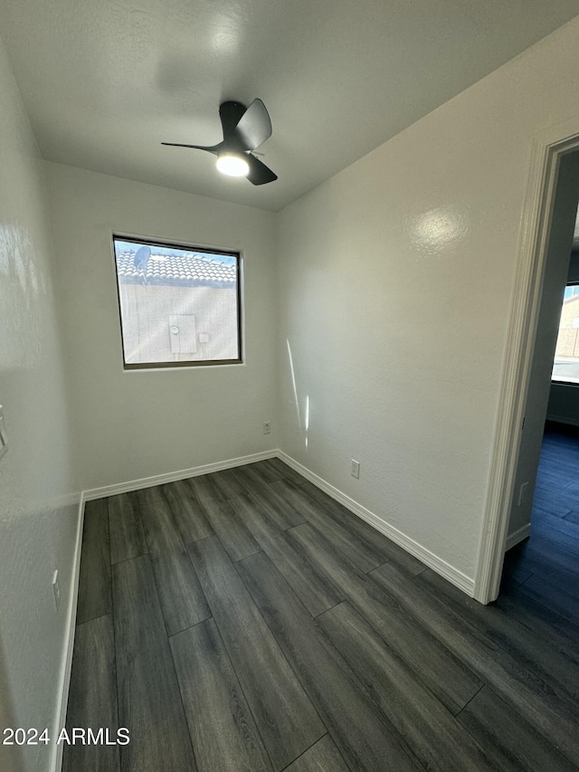 unfurnished room featuring ceiling fan, plenty of natural light, and dark hardwood / wood-style floors