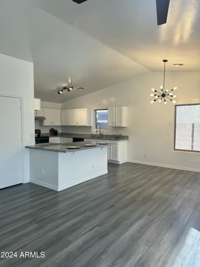 kitchen featuring white cabinets, lofted ceiling, dark hardwood / wood-style flooring, and kitchen peninsula