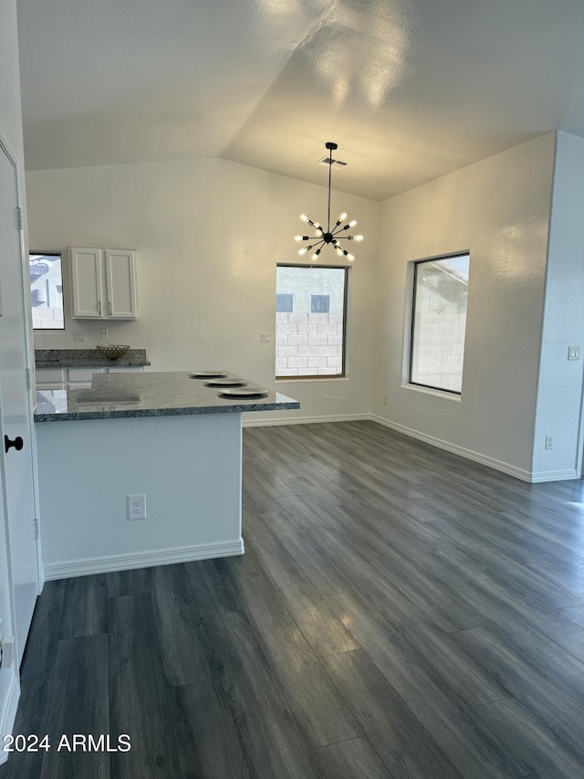 kitchen featuring dark wood-type flooring, an inviting chandelier, hanging light fixtures, white cabinetry, and kitchen peninsula