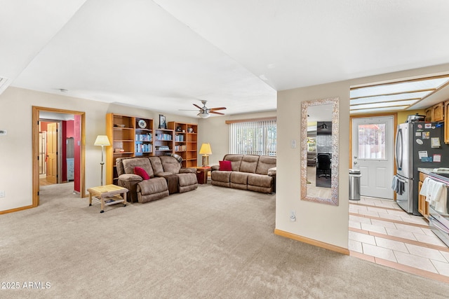 living room featuring ceiling fan and light colored carpet