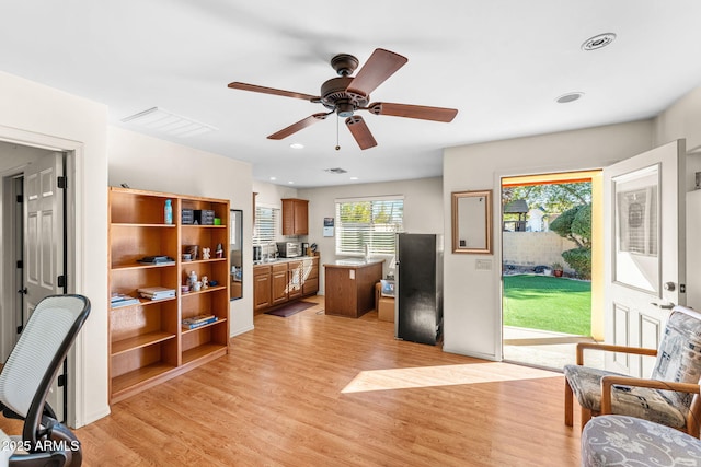 home office featuring ceiling fan and light hardwood / wood-style floors