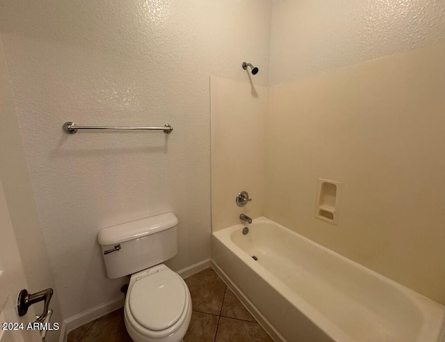 bathroom featuring tile patterned flooring, bathtub / shower combination, and toilet