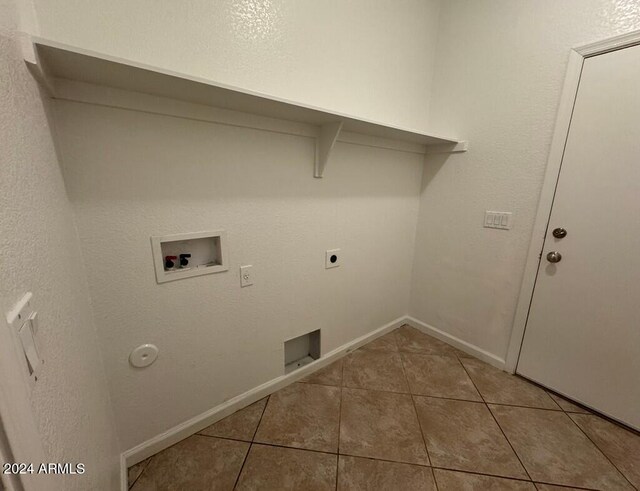 clothes washing area with electric dryer hookup, hookup for a gas dryer, hookup for a washing machine, and tile patterned flooring