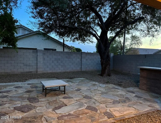 view of patio terrace at dusk