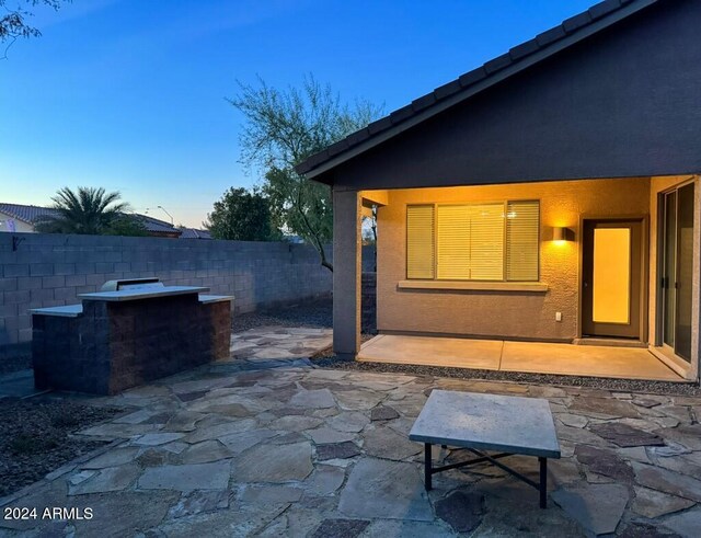 view of patio terrace at dusk