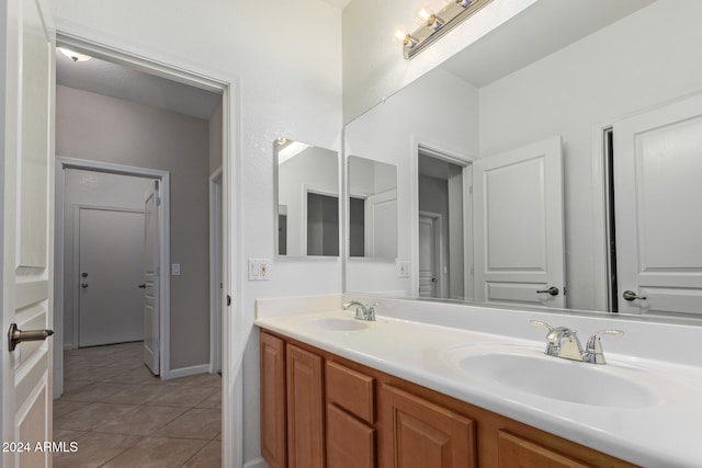 bathroom with tile patterned flooring and vanity