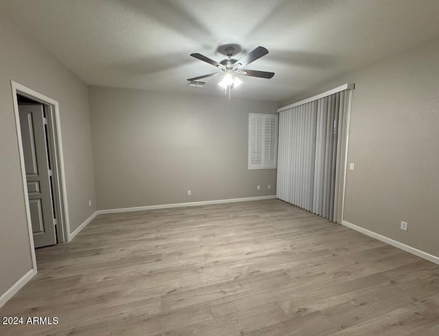 unfurnished bedroom featuring ceiling fan and light wood-type flooring