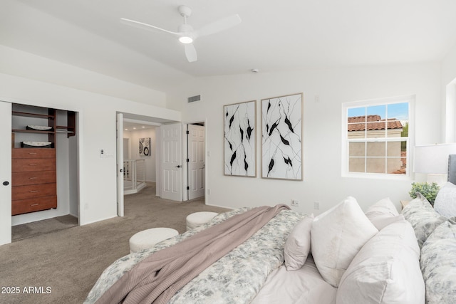 carpeted bedroom featuring a ceiling fan, visible vents, vaulted ceiling, and baseboards