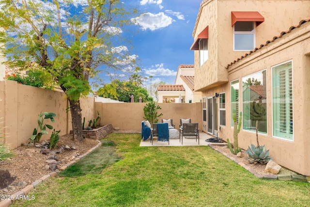 view of yard with a patio area, a fenced backyard, and an outdoor living space