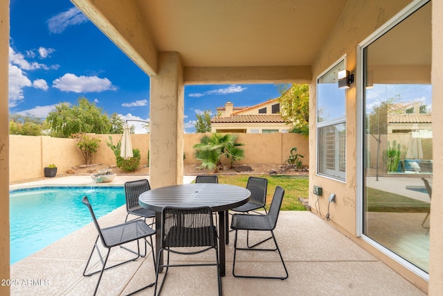 view of patio / terrace featuring a fenced backyard, outdoor dining area, and a fenced in pool