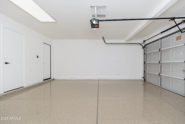 garage featuring a garage door opener and baseboards