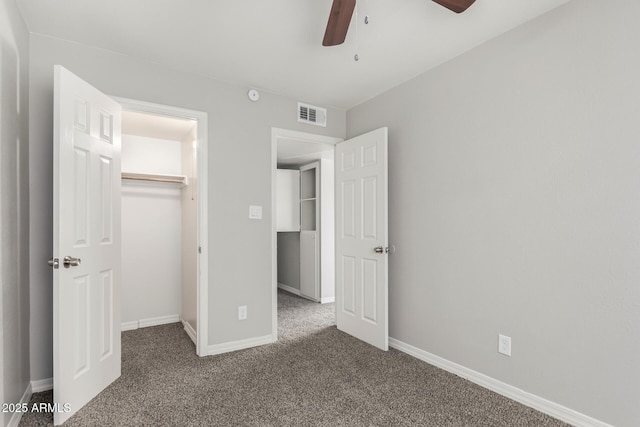 unfurnished bedroom featuring a closet, carpet flooring, baseboards, and visible vents