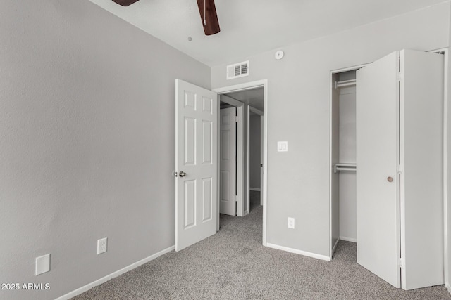 unfurnished bedroom featuring carpet, a closet, a ceiling fan, visible vents, and baseboards